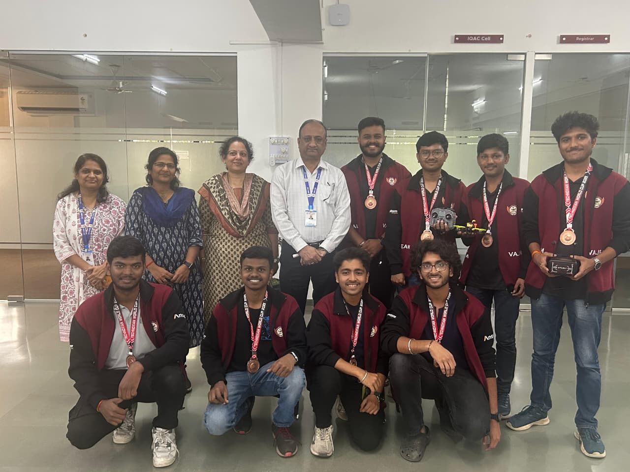Team VAJRA members holding their medals in a circle